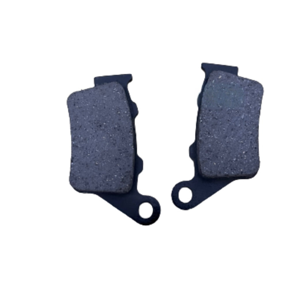 Pair of motorcycle brake pads with dark friction material on white background