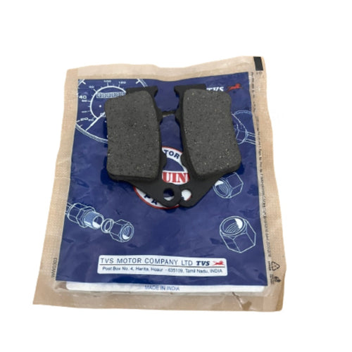 Motorcycle brake pads for TVS placed on branded blue packaging.