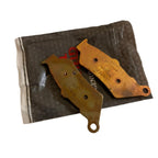 Motorcycle brake pads set on original packaging, metallic finish, close-up