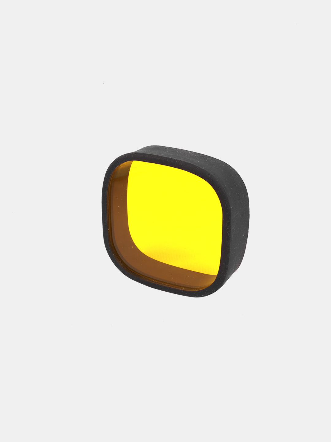 yellow fog light lens cap with black rubber edge on a plain white background