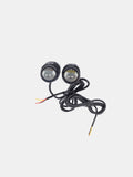 Pair of round motorcycle auxiliary LED fog lights with wiring on a white background