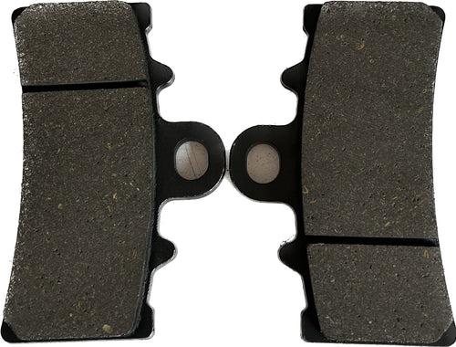 Close-up of motorcycle brake pads pair, new replacement parts on white background