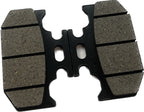 Close-up of motorcycle brake pad with grooved friction surface on white background