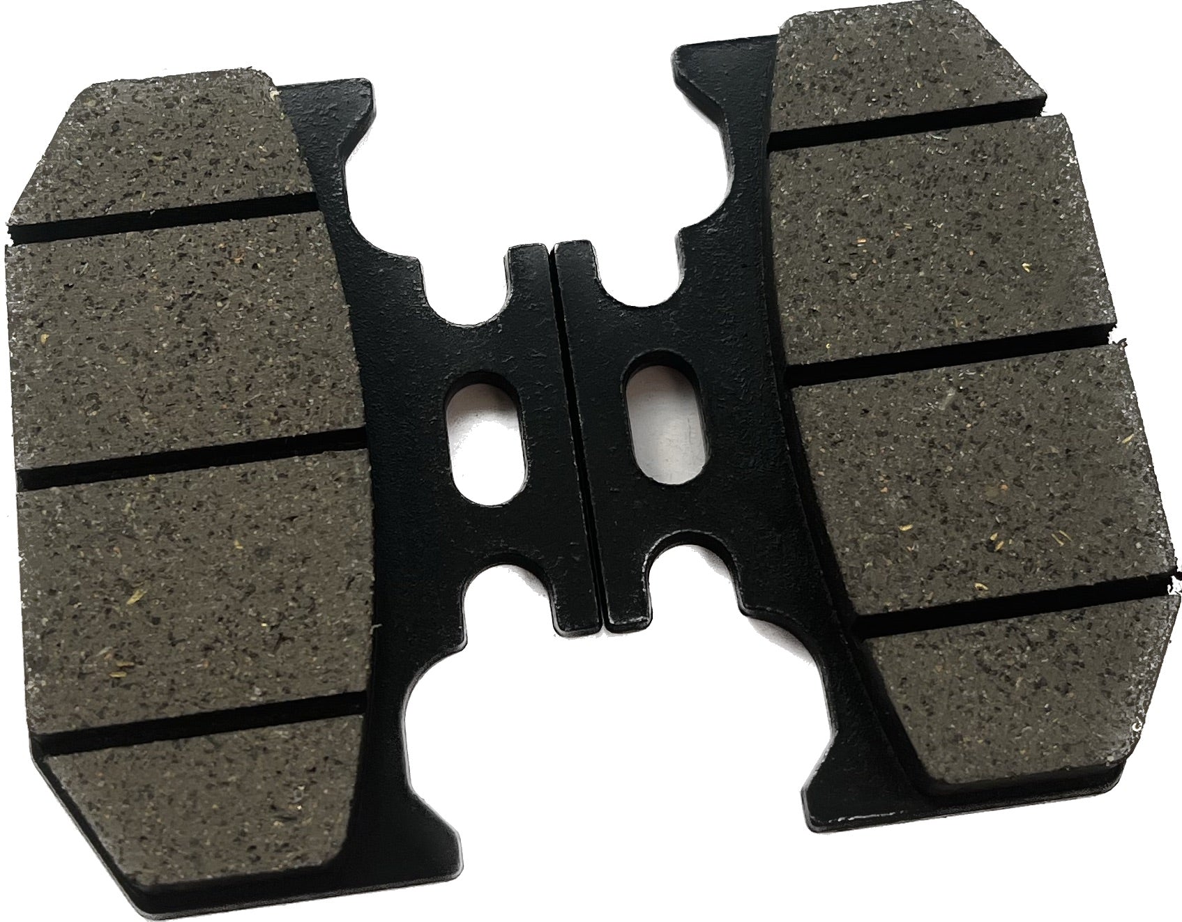 Close-up of motorcycle brake pad with grooved friction surface on white background