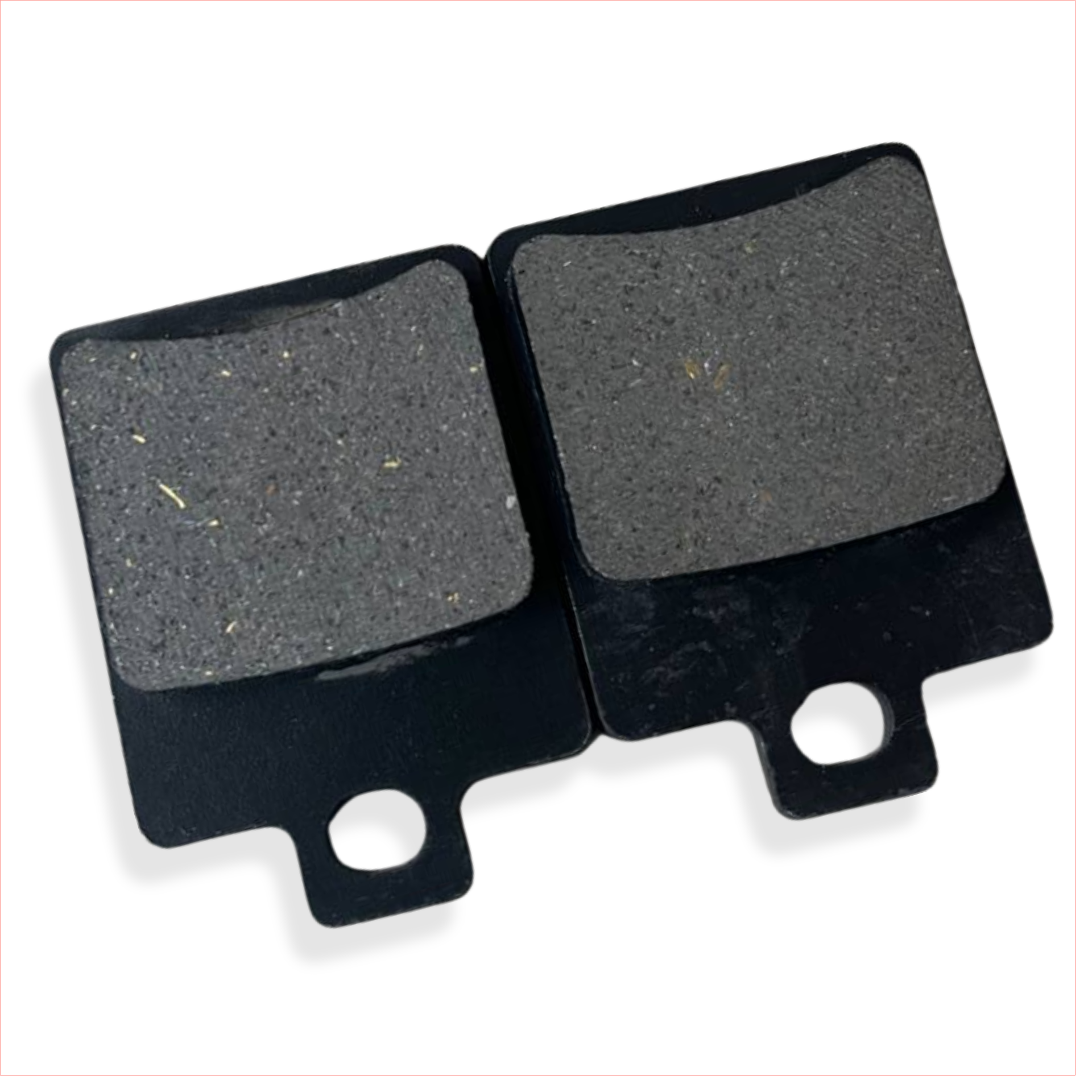 Close-up of two rectangular motorcycle brake pads with black metal backing.