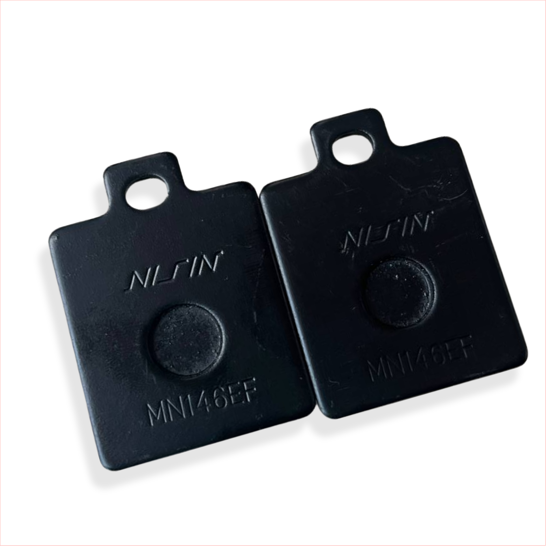 Black Nissin MN146EF motorcycle brake pad spacers on white background