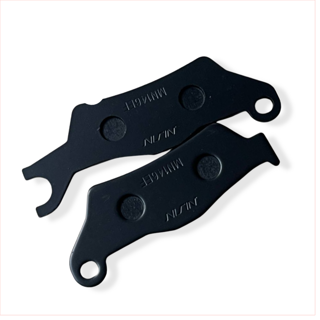 Pair of black motorcycle brake pads labeled NISSIN on white background