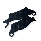 Pair of black motorcycle brake pads labeled NISSIN on white background