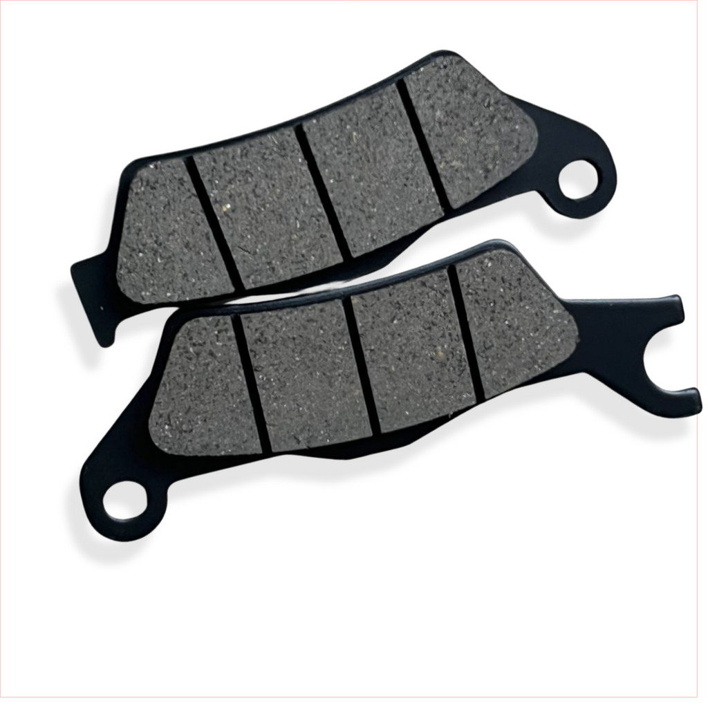 Motorcycle brake pads set on white background, close-up of friction material and grooves