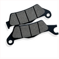 Motorcycle brake pads set on white background, close-up of friction material and grooves
