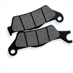 Motorcycle brake pads set on white background, close-up of friction material and grooves