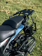 Motorcycle with rear luggage rack and saddle stay frame on grassy field