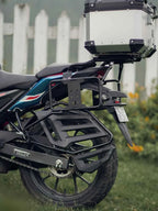 Motorcycle rear luggage carrier with saddle stay, pannier rack, and top box outdoors