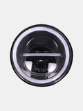 LED motorcycle headlight with white halo ring on a light background